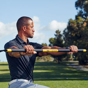 golfer twisting with trx rip trainer