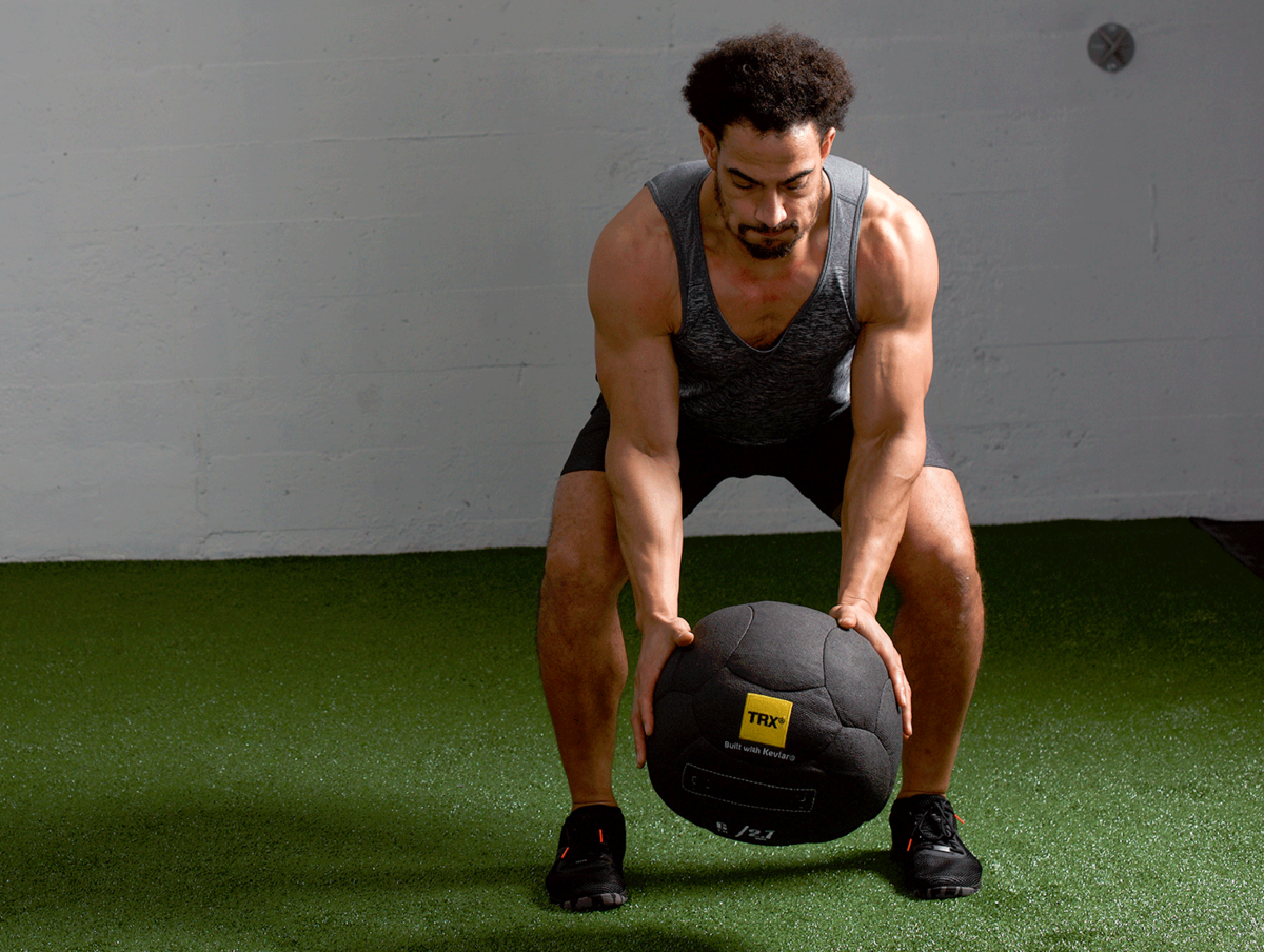 trainer doing medicine ball slam alternatives